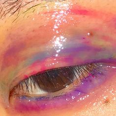 an eye with pink and purple streaks on it