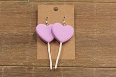 Approximately 3 inches, not including earring hook, these earrings dangle and do not lay directly on the earlobe. They are 2 different colors which include pink and purple. They lay facing forward. Trendy Heart Earrings For Birthday, Trendy Heart-shaped Earrings For Birthday, Pink Heart Earrings For Birthday, Trendy Purple Heart Earrings As Gift, Trendy Purple Heart Earrings For Gift, Trendy Heart-shaped Birthday Earrings, Trendy Purple Heart Earrings, Handmade Pink Heart Dangle Earrings, Playful Pink Earrings For Valentine's Day