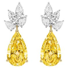 Magnificent Pear Shape Yellow Diamonds suspended from a Cluster of White Pear shape Diamonds. Yellow Diamonds weighing 10.01 Carats White Diamonds weighing 4.05 Carats. Set in Platinum and 18 Karat Yellow Gold Luxury High Luster Pear-shaped Jewelry, Luxury Yellow Gold Chandelier Earrings With Elegant Design, Luxury Yellow Gold Cluster Earrings For Formal Events, Luxury Vintage Yellow Jewelry, Luxury Festive Yellow Gold Danglers, Luxury Brilliant Cut Yellow Gold Cluster Earrings, Luxury Yellow Gold Danglers For Women, Yellow Diamond Drop Earrings, Yellow Diamond Earrings