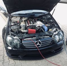 a mercedes benz with its hood open and the engine still in it's compartment