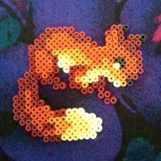 an orange and white cat made out of perler beads