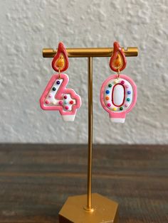 Celebrate your birthday in style with these unique handmade birthday candle earrings. Each pair is custom-made so you can personalize your earrings based on your age. Perfect for a special occasion or as a thoughtful gift. White with a delicate pink finish. Nickel-free Pink Earrings For Birthday, Pink Drop Earrings For Birthday, Pink Jewelry With Matching Earrings For Birthday, Cute Earrings For Birthday And Mother's Day, Pink Earrings For Valentine's Day Celebration, Cute Earrings For Birthday Or Mother's Day, Nickel-free Earrings For Birthday, Pink Dangle Jewelry For Birthday Gift, Pink Party Earrings For Mother's Day