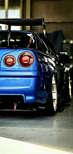 the rear end of a blue sports car