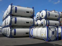 large stacks of propane tanks are stacked on top of each other