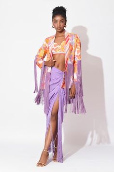 Orange and lavender crop top with floral print. Paired with floral printed jacket with fringe detailing and ruched skirt detailed with fringes on hem. - Aza Fashions Fitted Sets With Tassels In Traditional Drape, Spring Party Sets With Tassels, Fitted Sets With Tassels For Spring, Fitted Spring Sets With Tassels, Fitted Tassel Sets For Spring, Lavender Crop Top, Embellished Skirt, Printed Jacket, Women Skirt