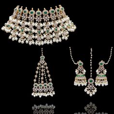 Delve into the mesmerizing and ethereal ensemble curated especially for your big day! Charming set beautifully laced with emerald stones, depicting the sparkle of a thousand stars with CZ stone and inheriting classic grace with white pearl detailing. The set includes a necklace a matching maang teekah, a jhoomar/passa and a pair of beautiful jhumkey earrings with saharay. Approximate earrings length is 3". Please click on the video for a detailed view of the product. Designed over high-quality b Elegant Festive Bridal Necklace With Emeralds, Elegant Festive Emerald Bridal Necklace, Elegant Festive Bridal Emerald Necklace, Festive Elegant Emerald Bridal Necklace, Green Pearl Bridal Necklace For Wedding, Elegant Emerald Jewelry Sets With Stone Work, Exquisite Green Bridal Necklace For Wedding, Emerald Jewel Bridal Necklace For Wedding, Elegant White Pearl Sets