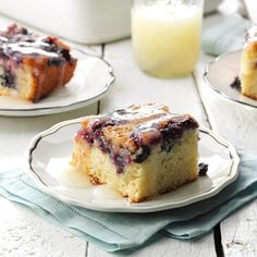 a piece of blueberry coffee cake on a plate next to a glass of milk