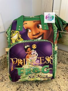 the princess and the frog backpack is on display