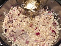 rice and onions being cooked in a pan