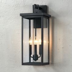 an outdoor wall light with three lights on it