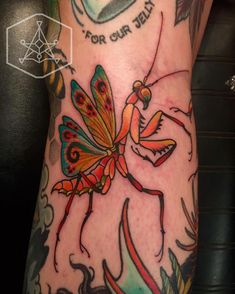 a tattoo on the leg of a person with a butterfly