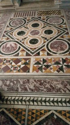 the floor is decorated with many different colors and designs, including geometrics on it