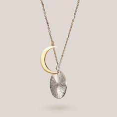 Featuring an 18k gold vermeil crescent moon eclipsing a hand-engraved sterling silver disc, the Eclipse Necklace is made for the lovers of the night sky. The two brilliant pendants hang independently from a 18" - 20” sterling silver satellite chain featuring micro sterling silver beads. Our best selling necklace for 5+ years. Celestial Moon Phase White Gold Necklace, Celestial White Gold Moon Phase Necklace, Sterling Silver Moon Phase Necklace In White Gold, Sterling Silver White Gold Necklace With Moon Phase, White Gold Sterling Silver Moon Phase Necklace, White Gold Moon Phase Necklace, White Gold Sterling Silver Necklace With Moon Phase, Celestial Moon Necklace In White Gold, Silver Medallion Necklace With Moon Charm