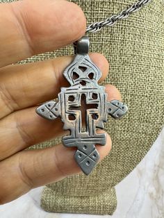 Vintage Ethiopian Coptic Christian Cross Silver Pendant From Ethiopia, Africa.This antique silver pendant on a 20" chain features a Coptic Christian cross, handcrafted by Ethiopian Metalsmiths. The pendant is made of ethnic silver and has a beautiful silver color. It is an original piece from Ethiopia, Africa, and is perfect for collectors of African ethnographic jewelry. The pendant is a unique and rare find, and would make a great addition to any jewelry collection. SKU 860 Ethiopian Coptic Cross, Coptic Cross, Ethiopian Jewelry, African Style, Christian Cross, Ethiopia, Halloween Shopping, Silver Pendant, Silver Color