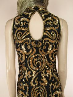 Beaded and sequined dress Hight neckline Back zipper closure It is fully lined with a satin polyester Colour: Black and gold Fabric: Silk chiffon, satin Measurements Bust: 98 cm - 38.6 inches Waist: 80 cm – 31.5 inches Hip: 104 cm - 40.9 inches Length: cm. 100 - 39.4 inches Gold Sequin Evening Dress For Night Out, Gold Sequin Dress For Night Out, Gold Sequin Dress For Night Out Evening, Holiday Black Sequin Fabric For Cocktail, Holiday Cocktail Black Sequin Fabric, Gold Sleeveless Sequin Fabric For Party Season, Black Sequin Fabric For Evening Cocktail, Black Sequin Fabric For Cocktail Evening, Glamorous Gold Sequin Fabric For Cocktail