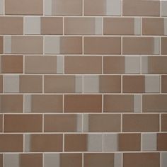 a brown and white tiled wall with no one in it