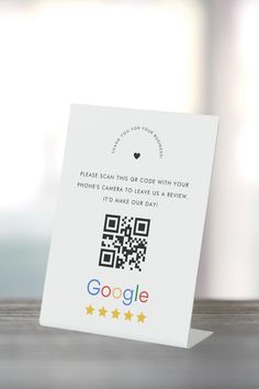 a card with a qr code on it sitting on top of a wooden table