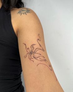 a woman's arm with a tattoo on it and a flower in the middle