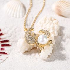 Dive into the mystery of the sea with our pearl crab necklace. She'll be sweet as can be when she wears this charming crab pendant. Created in sterling silver, this clever crustacean features a cultured freshwater pearl "shell" and stones-accented appendages. A delightful look with summery fashions, this clever crab is buffed to a brilliant shine and suspends freely along an sterling silver chain.Carat Weight: 4.2 ctStone Size: 8 mmStone Type: Jeulia® StoneNumber of Stones: 1 Stone Shape: RoundS Ocean-inspired Pearl Pendant Necklace As Gift, Gift Pearl Pendant Necklace With Lobster Clasp, Gift Pendant Pearl Necklace With Lobster Clasp, Crab Necklace, Pearl Shell, Cultured Pearls, Sterling Silver Chain, Sterling Silver Necklace, Sterling Silver Necklaces