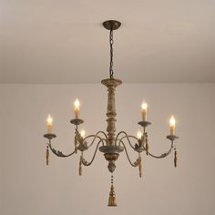 a chandelier hanging from the ceiling in a room with white walls and flooring