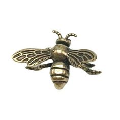 a gold colored metal bee with wings