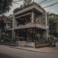 a concrete building with plants growing on the roof and balconies above it's windows