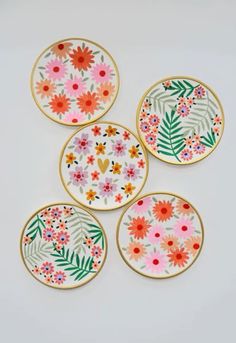 four plates with flowers painted on them