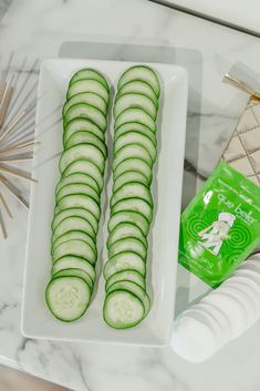 cucumber slices are arranged on a white plate