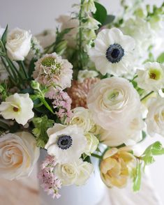 a vase filled with white and pink flowers