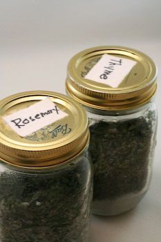 two jars filled with different types of herbs