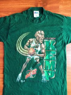 Rare Vintage Shawn Kemp Caricature 90'S Nba Basketball Shirt Vintage Cartoon Print T-shirt For Streetwear, Casual Tops With Vintage Print For Fan Merchandise, Cartoon Print Tops For Streetwear Fan Apparel, Pop Culture Green Tops For Streetwear, Green Character Print Top For Streetwear, Retro Green Tops With Front Print, Vintage Sublimation Print Tops For Fan Merchandise, Vintage Green Top With Front Print, Retro Tops With Cartoon Print For Fan Conventions