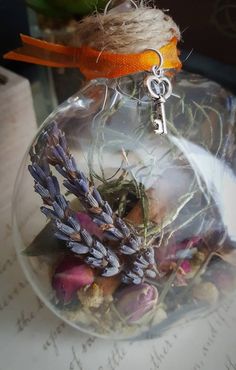 an ornament filled with dried flowers on top of a table