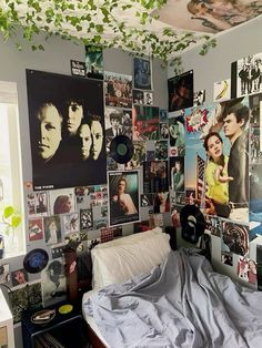 a bedroom with many pictures on the wall