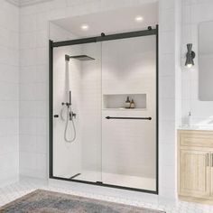 a bathroom with a walk in shower next to a sink