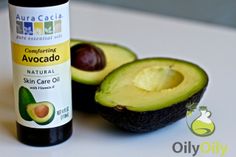 an avocado is next to a bottle of oil