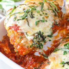 chicken parmesan recipe in a white casserole dish with cheese and herbs