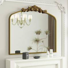 a white fireplace with a mirror and candles on the mantel in front of it