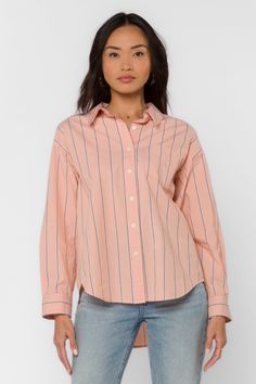 This Randall Peach Stripe Shirt is the perfect addition to your wardrobe. The long sleeve boyfriend shirt features a single chest pocket and a high low hem, making it both stylish and functional. The classic striped design adds a touch of sophistication to any outfit. Stay comfortable and fashionable with this must-have piece. Material: 100% Cotton Machine wash cold or hand wash Color: Peach Stripe Model is 5'9" and wearing a size S Imported Trendy Cotton Shirt With Roll-up Sleeves, Trendy Orange Cotton Blouse, Everyday Spring Shirt With Collared Neckline, Orange Button-up Cotton Blouse, Orange Cotton Button-up Blouse, Orange Cotton Blouse For Work, Orange Cotton Blouse With Button Closure, Summer Peach Cotton Shirt, Peach Cotton Summer Shirt