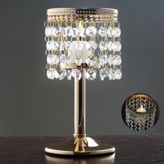 a table lamp with a glass shade on it and a candle holder next to it