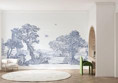 a living room with a large mural on the wall and a chair next to it