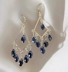 Elegant chandelier earrings crafted from sterling silver and adorned with faceted iolite beads. Featuring a lever-back closure and a 2-inch drop, these earrings are sure to add a touch of sophistication to any outfit. Elegant Chandeliers, Chandelier Style, Earring Crafts, Chandelier Earrings, Diy Earrings, Wire Jewelry, Jewelry Earrings Dangle, Dangle Drop Earrings, Dangle Earrings