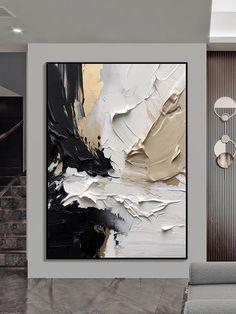 an abstract painting hangs on the wall in a modern living room