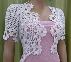 a mannequin wearing a pink dress with white crochet