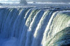 an advertisement for niagara parks in front of a large waterfall with water pouring over it