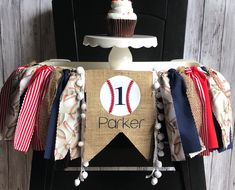 a baseball themed birthday banner with a cupcake on top