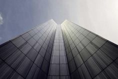 looking up at the top of two tall buildings