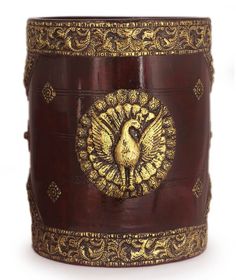 an ornately decorated wooden box with a golden peacock on it's lid and sides