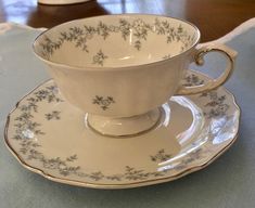 a cup and saucer sitting on top of a table