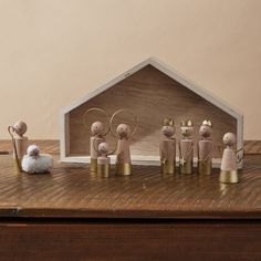 a group of small wooden figurines sitting on top of a table