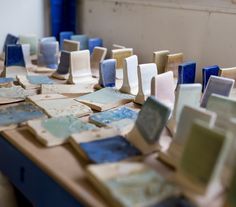 many different pieces of glass sitting on top of a wooden table next to each other